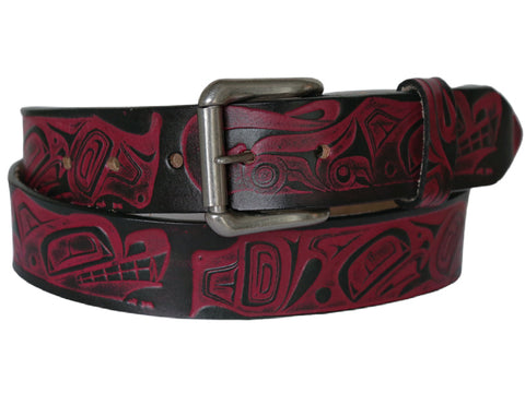 A leather belt with intricate red embossed designs featuring orca and wolf motifs, and a metallic buckle.
