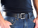 Black leather belt with silver roller buckle worn with jeans