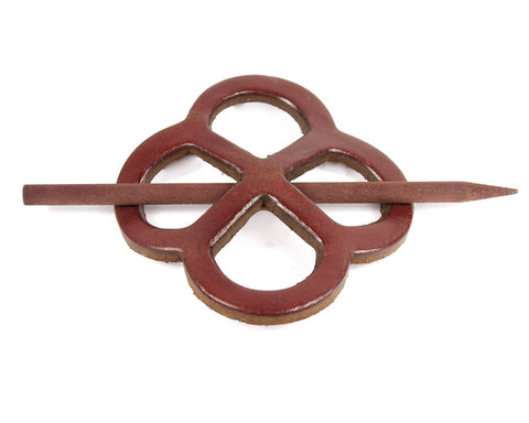 Red metal hairpin with a unique design on a white background